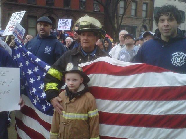 Proud Union Firefighters and their Families stand shoulder to shoulder on the steps of the State State House in Trenton during a solidarity rally on 2/25/2011.